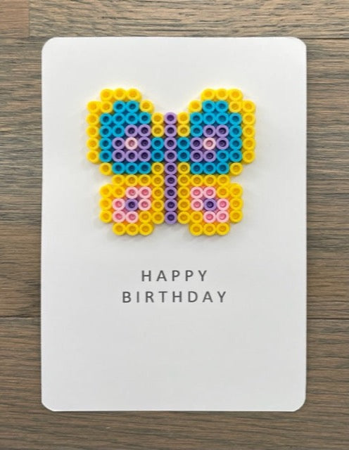 Picture of a Happy Birthday card with yellow, purple, pink, blue butterfly on it