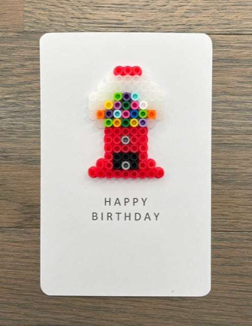 Picture of a Happy Birthday card with a red gum ball machine on it