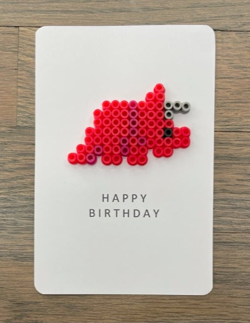 Picture of a Happy Birthday card with a red dinosaur on it