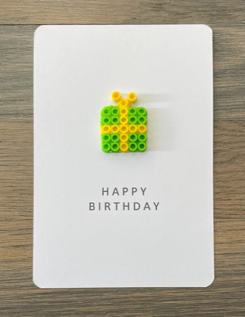 Picture of a Happy Birthday Card with lime green gift with yellow ribbon on it