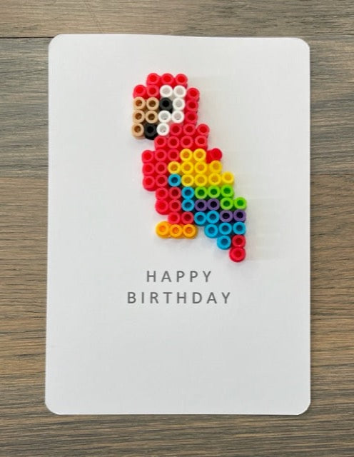 Picture of a Happy Birthday card with a colorful parrot on it