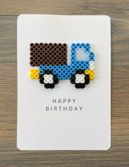 Picture of a Happy Birthday card with blue, dark brown truck on it