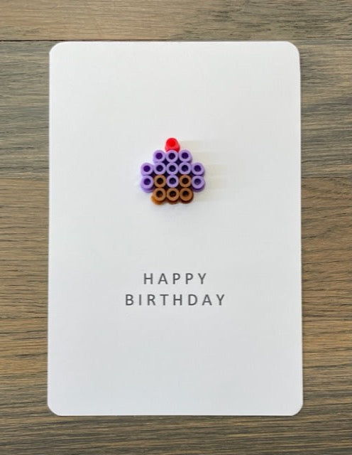 Picture of a Happy Birthday card with a purple cupcake on it