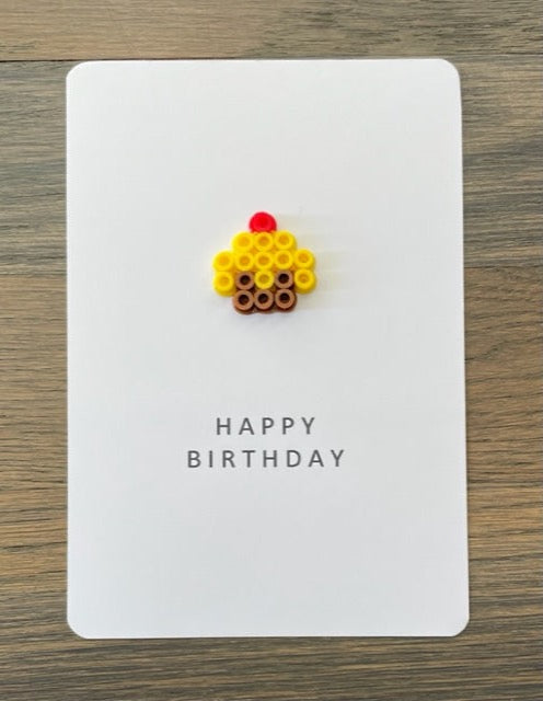 Picture of a Happy Birthday card with a little yellow cupcake on it