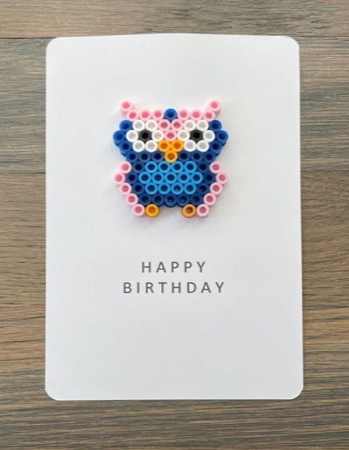 Picture of a Happy Birthday card that has a pink, navy blue, light blue owl on it