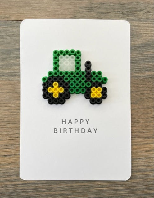 Picture of a Happy Birthday card with a green tractor on it