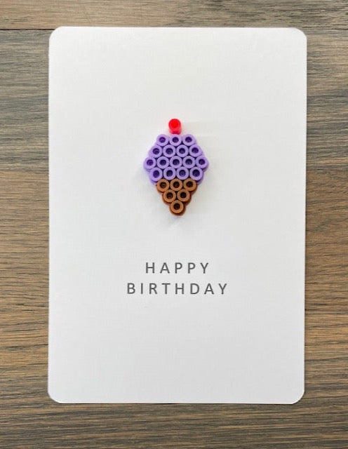 Picture of a Happy Birthday card with a purple ice cream cone on it